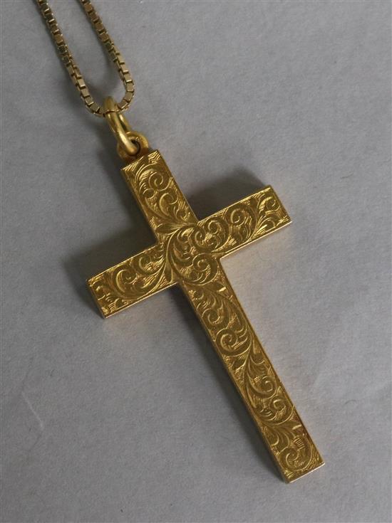 An early 20th century engraved 15ct gold cross pendant on a 9ct gold chain.